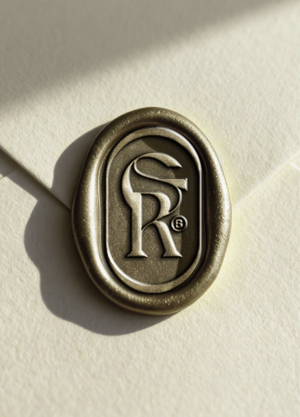 Grand Regent monogram pressed into a champagne-gold wax seal on ivory stationery